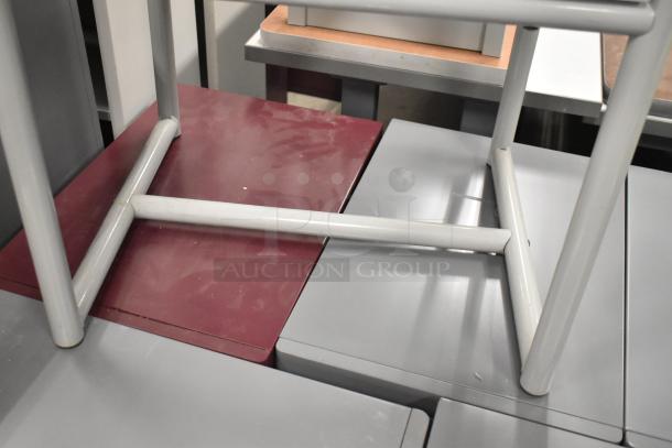 Gray table with metal frame, showing understructure. Appears sturdy with minor surface wear. Suitable for modern decor.