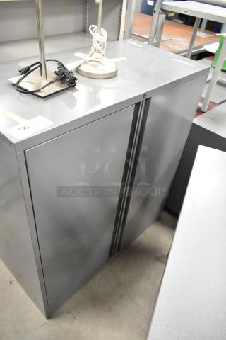 Gray metal 2-door cabinet, sleek design, excellent condition, suitable for office or home storage. Includes label "122".