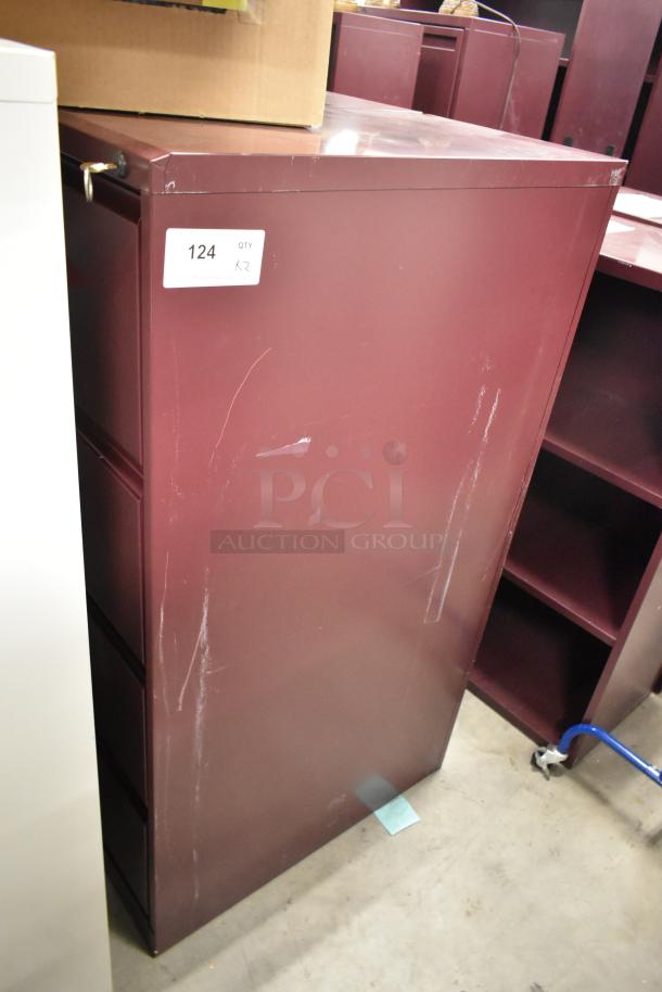 Two maroon metal filing cabinets, four drawers each, some surface scratches, label "124 QTY 2" on one.