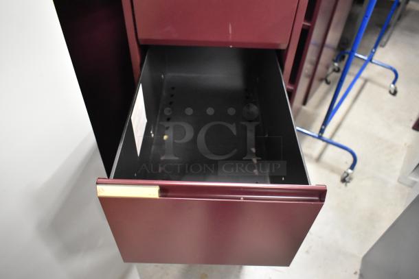 Maroon metal 4-drawer filing cabinet, one open drawer, sturdy condition, includes label holder, auction for two units.