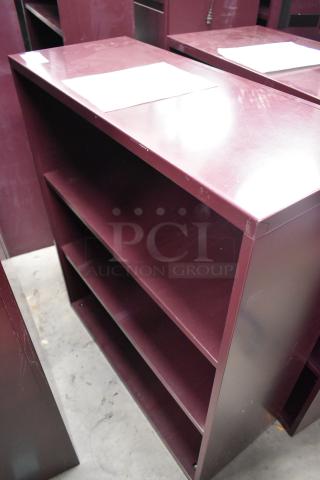 Two maroon metal book shelves, three shelves each, minor scratches, sturdy condition, auction lot of two.