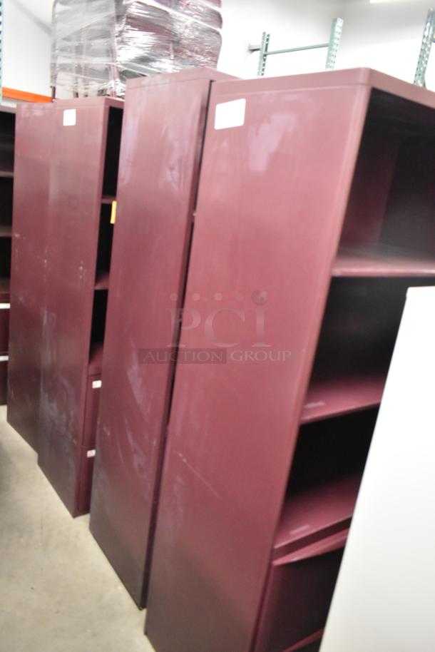 Two maroon metal book shelves, 4-shelves each, in used condition with visible scuffs. Ideal for office or storage use.