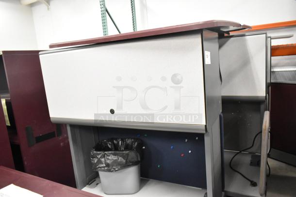 2 light gray desks with overhead cabinet. Slight wear visible. Includes tags. Bidding for two. Ideal for office use.