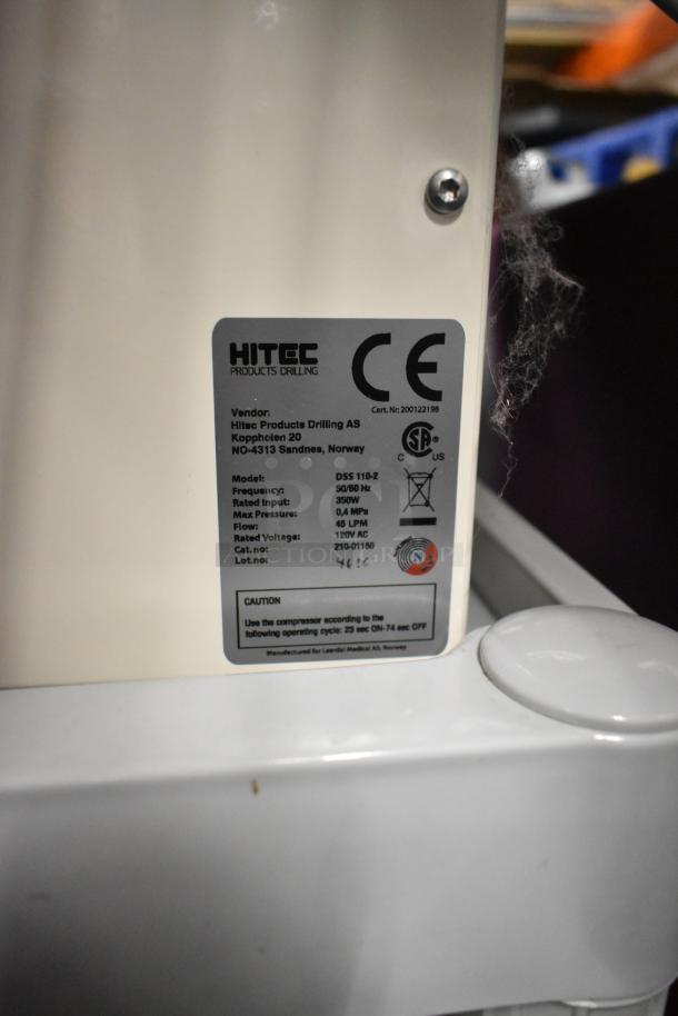 Hitec DSS 110-2 Air Compressor, 120V, single-phase, label with model details, vendor info, and caution notes.