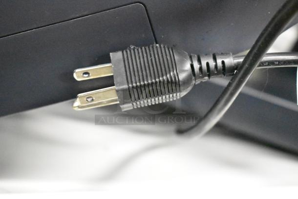 Power plug connection for Elo POS Monitor, showing two-prong plug and black cable. Close-up detail.