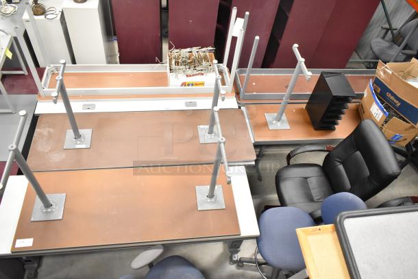 10 various gray tables with disassembled legs, showing wear. Includes office chairs and boxes. Sold as a lot, 10 times bid.