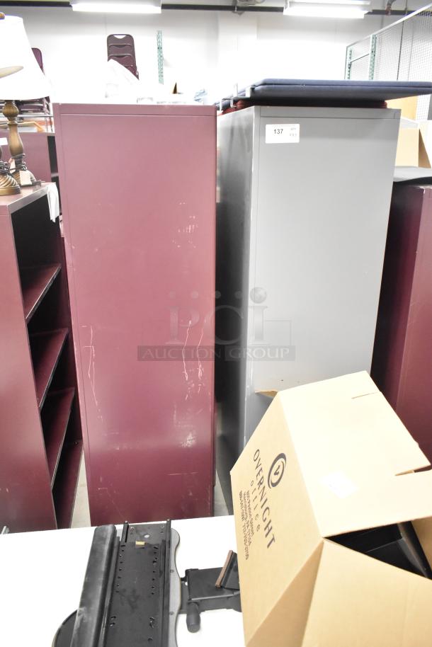 Two metal bookshelves, one maroon and one gray, with visible wear. Includes auction tag “137.” Multiples offered per bid.