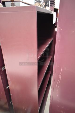 Maroon metal book shelves with three shelves each. Slightly worn with visible scratches. Auction offers two shelves.