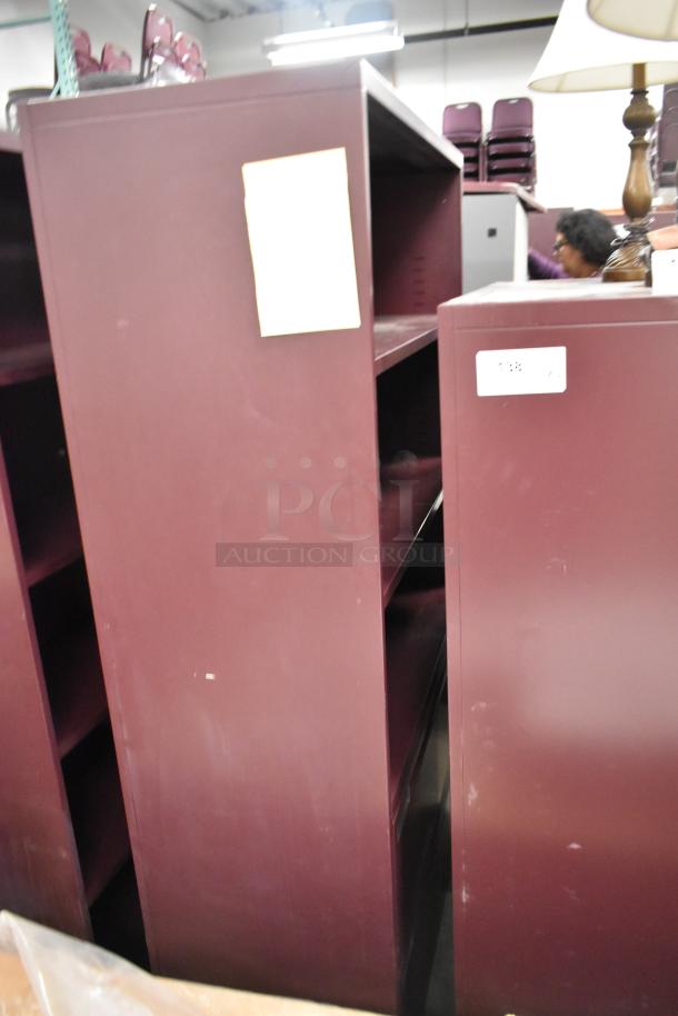 Maroon metal book shelves, various sizes, slight wear visible, ideal for office or home use. Auction includes two units.