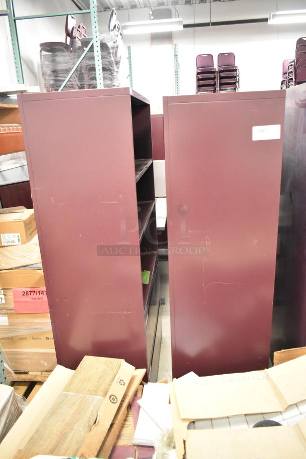 Two maroon metal bookshelves, scratch marks visible, multipurpose use, label marked "141" on one unit.