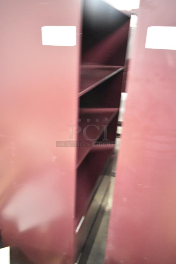 2 maroon metal book shelves, multiple tiers, good condition, visible white labels, durable, ideal for office or home use.