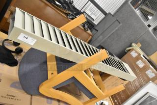 Buddy Products Tan Metal Time Card Holder with multiple slots, visible wear, and item tag labeled "142."