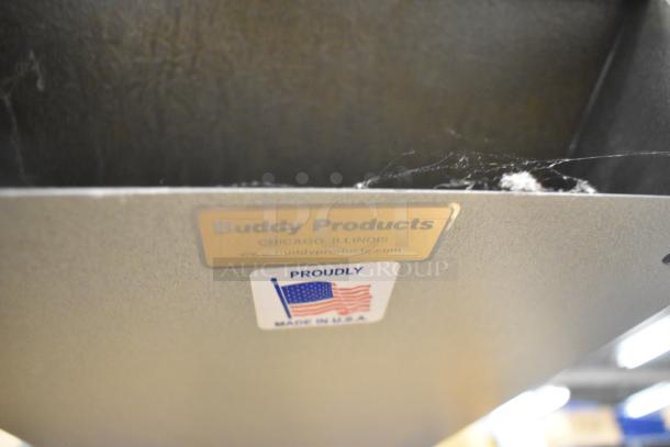 Buddy Products tan metal time card holder, labeled from Chicago, Illinois, with a "Made in USA" sticker. Shows signs of wear.