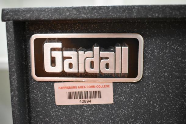 Gardall gray metal safe, single compartment, no combination, "Harrisburg Area Comm College" label with barcode 40894.
