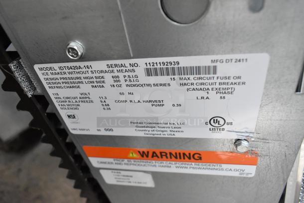 Label of new Manitowoc IDT0420A-161 ice machine, showing model, serial number, voltage, and warning details.