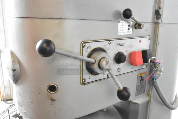 Hobart M-802 metal commercial dough mixer, control panel showing speed settings and operation labels. Condition shows signs of wear.