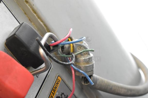 Close-up view of wiring and warning label on a Hobart M-802 mixer. Wire colors: red, green, blue.