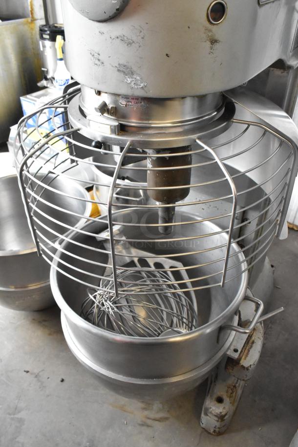 Hobart M-802 commercial 80-quart dough mixer with bowl guard, dolly, paddle, whisk attachments. 3-phase, 200V. Good condition.