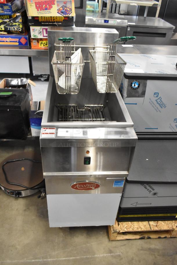 Brand new 2024 Avantco 177EF40B stainless steel 40 lb. electric fryer with two metal baskets, 208V, 1 phase, minor dents visible.