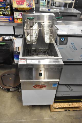 Brand new 2024 Avantco 177EF40B stainless steel 40 lb. electric fryer with two metal baskets, 208V, 1 phase, minor dents visible.