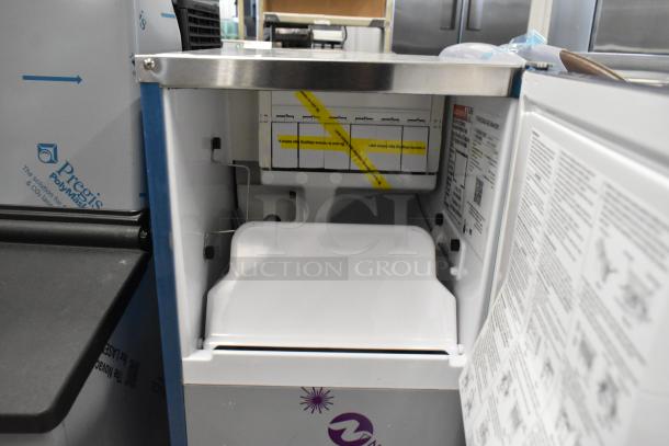 BRAND NEW 2025 Hoshizaki AM-50BAK stainless steel ice machine, showing interior with bin and labeling details.