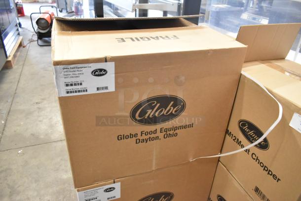 Brand new Globe G12 stainless steel meat slicer in original box, labeled "scratch and dent," 115V, 1 Phase.