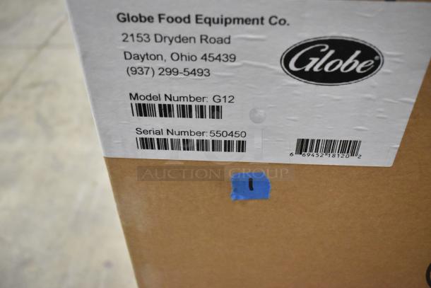 Box label for Globe G12 Meat Slicer. Shows model, serial number 550450, and manufacturer's contact info. Brand new, minor scratches.