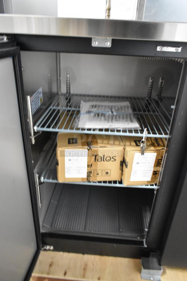 Brand new Avantco 178UDD72HC kegerator interior with wire shelves, showing packaging and installation documents.