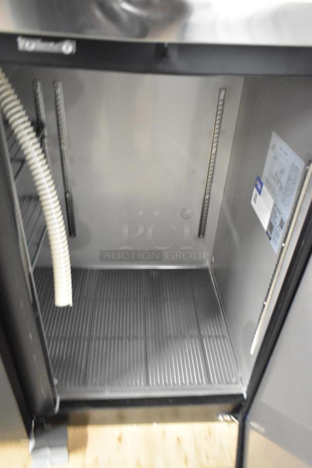Brand new Avantco 178UDD72HC kegerator interior, visible shelving and hose, scratch and dent condition.