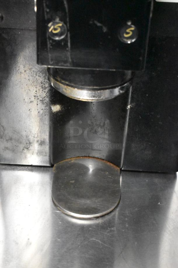 La Marzocco Swift E.P.S.B. espresso grinder, metal body, missing hoppers, 120V, 1-phase, used condition, visible wear.