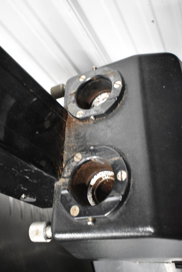 La Marzocco Swift E.P.S.B. commercial espresso grinder, black metal, missing hoppers, 120V, 1 phase, visible rust and wear.