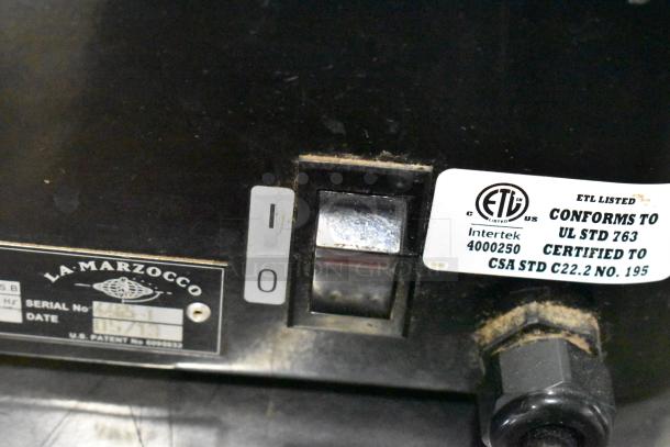 La Marzocco Swift E.P.S.B. metal commercial espresso grinder, missing hoppers, ETL listed, 120V, 1 phase, serial labels shown.