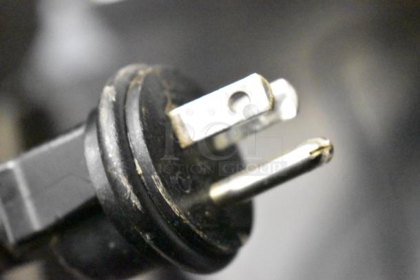 Close-up of a power plug for Mahlkonig Ditting KR1203 coffee grinder, highlighting prongs and slight wear.