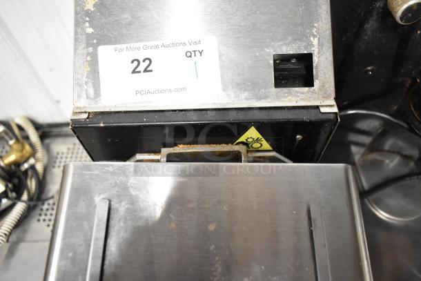 Cornelius NG2000 metal commercial nut butter grinder, 120V, 1 phase. Shows wear; auction tag and warning label visible.