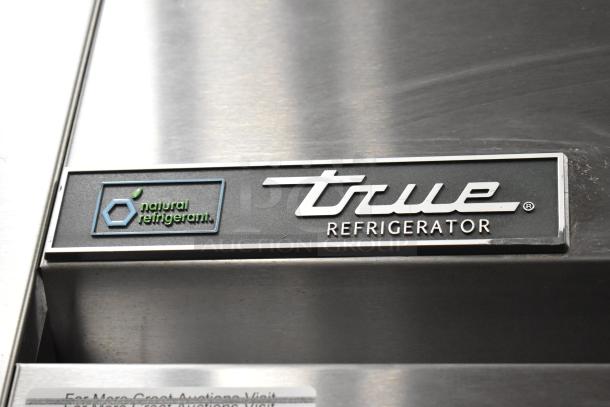 2022 True TG2R-2S-HC stainless steel reach-in cooler, two-door, poly-coated racks, commercial casters, True branding.