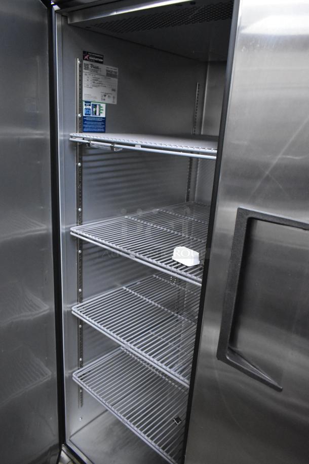 True TG2R-2S-HC stainless steel commercial cooler, 2 doors, poly coated racks, on casters. Model and label details visible.