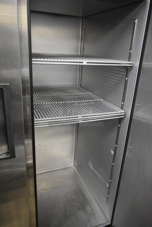 2022 True TG2R-2S-HC stainless steel 2-door reach-in cooler with poly-coated racks, in excellent condition.