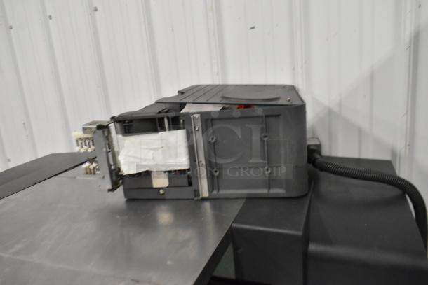 Hobart AW-4600 metal commercial floor heat shrink wrap station, sturdy design, includes power cables; suitable for wrapping operations.