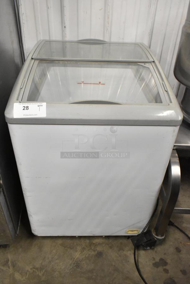 SD-151 metal commercial chest freezer merchandiser with glass top, on commercial casters. 115 volts, 1 phase. Light wear visible.