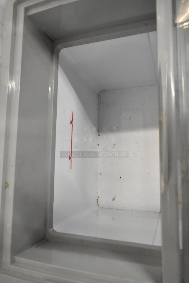 Metal commercial chest freezer SD-151, interior view with red capacity line, on commercial casters, 115V, 1 phase.