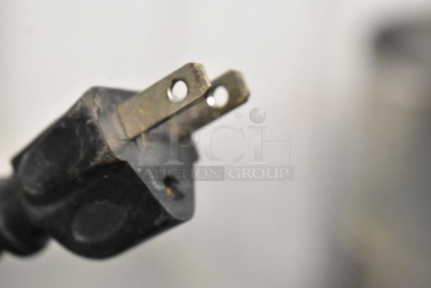 Close-up of a two-prong electrical plug for the SD-151 Metal Commercial Chest Freezer Merchandiser, 115 volts, 1 phase.