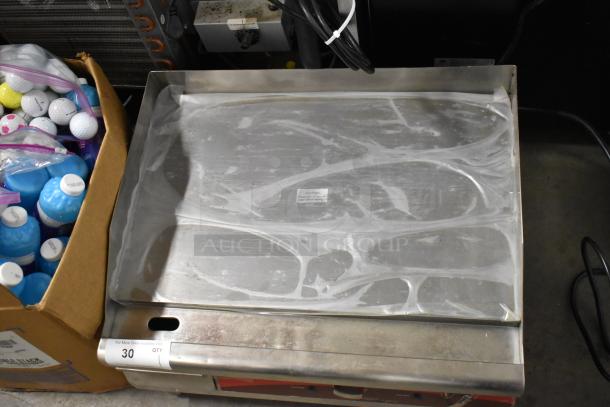 Avantco 177EG24N stainless steel countertop electric griddle, 208/240V, 1 phase, with protective film, in auction setting.