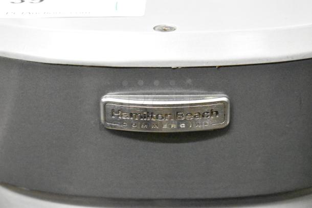 Hamilton Beach HMD400 Commercial Milkshake Mixer, metal finish, 3 heads, 120V, good condition. Brand label visible.