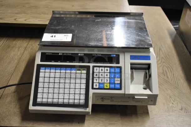 CAS LP-1000 metal countertop scale, 120V, 1 phase, featuring numeric keypad and label printer. Good condition.