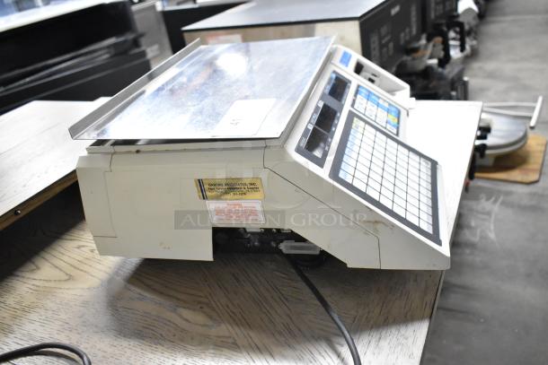 CAS LP-1000 metal countertop scale in working condition. Features digital display and keypad. Uses 120 volts, 1 phase.