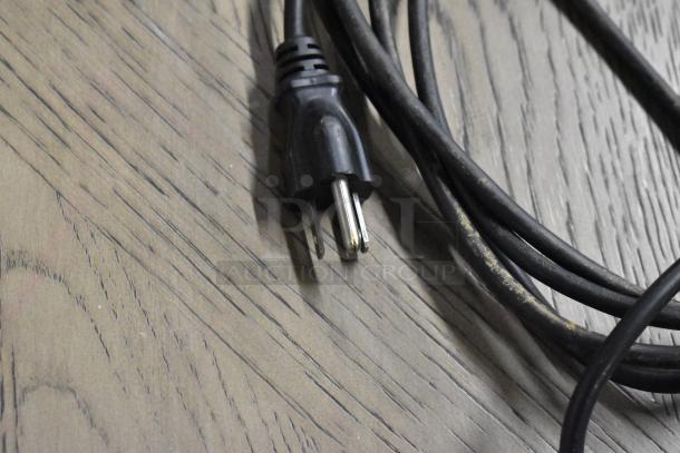 CAS LP-1000 metal countertop scale power cord. 120 volts, 1 phase. Plug and cord visible on wood surface.