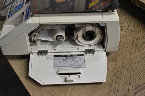 CAS LP-1000 Metal Countertop Scale, 120 Volts, 1 Phase, features digital controls, label roll compartment, and stainless steel weighing platform.