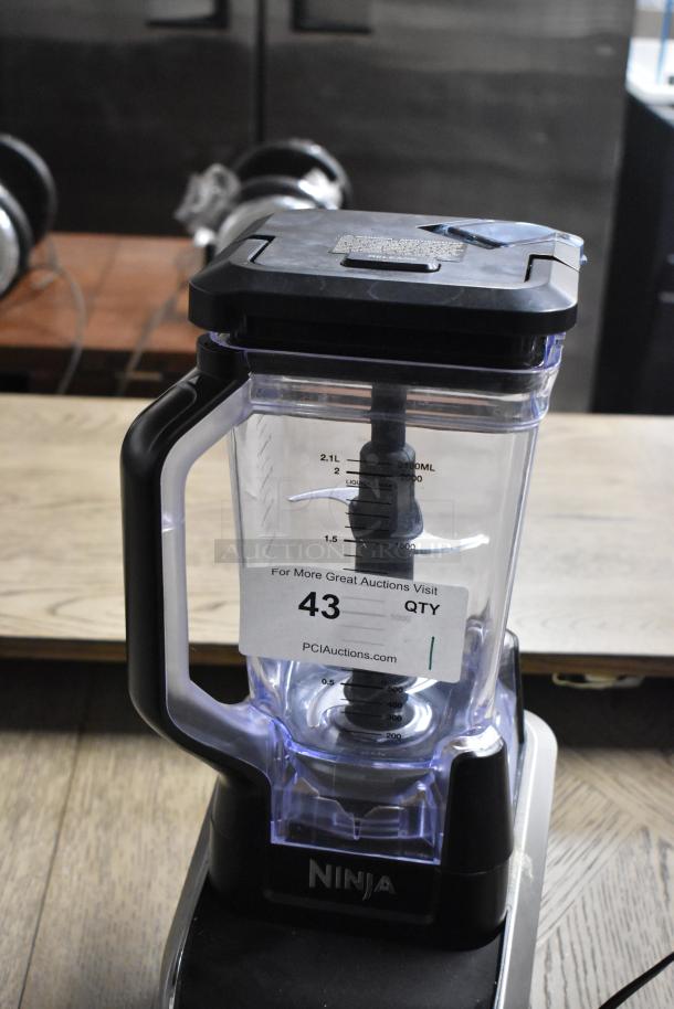 Ninja GL642 metal countertop blender with pitcher, 120 volts, 1 phase. Features measuring scale, model label, and auction tag.