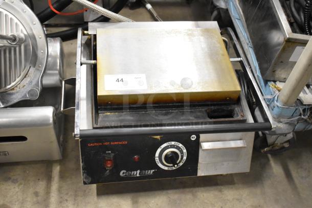 Centaur Metal Commercial Countertop Panini Press with temperature dial, power switch, and caution label, minor wear visible.