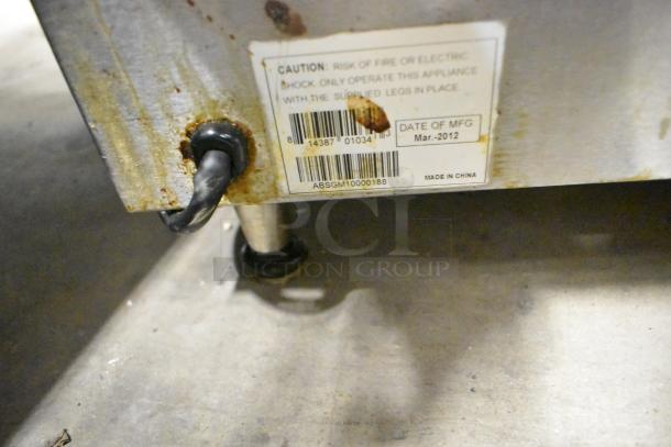 Centaur Metal Commercial Countertop Panini Press, manufacturing date March 2012, rusty finish, visible caution label.